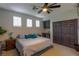 Cozy bedroom with neutral colors, ceiling fan, plush bed, and window with wood shutters for natural light at 1301 Kingdom St, Las Vegas, NV 89117
