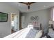 Bedroom featuring neutral colors, ceiling fan, plush bed, and doorway to updated bath at 1301 Kingdom St, Las Vegas, NV 89117