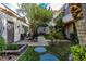 Landscaped courtyard featuring stone pavers, seating, and manicured greenery at 1301 Kingdom St, Las Vegas, NV 89117