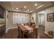 Dining room with tray ceiling, hardwood floors, and adjacent granite countertop at 1301 Kingdom St, Las Vegas, NV 89117
