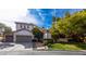 Beautiful two-story home featuring a three car garage, landscaped front yard, and a red tile roof at 1301 Kingdom St, Las Vegas, NV 89117