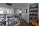 Beautiful curved staircase with wrought iron railing overlooking the foyer with wood floors at 1301 Kingdom St, Las Vegas, NV 89117