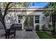 Charming courtyard entrance with stucco walls, tiled walkway, and wrought iron bench at 1301 Kingdom St, Las Vegas, NV 89117