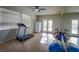 Large home gym features a ceiling fan, mirrored walls, and exercise equipment at 1301 Kingdom St, Las Vegas, NV 89117