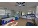 Spacious home gym with mirrored wall, exercise equipment, and ceiling fan at 1301 Kingdom St, Las Vegas, NV 89117