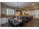 Open kitchen and dining area with stainless appliances, stone countertops, and stylish pendant lighting at 1301 Kingdom St, Las Vegas, NV 89117