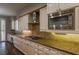 Kitchen counter with stainless appliances, light wood cabinetry, and stone back splash at 1301 Kingdom St, Las Vegas, NV 89117