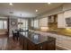 Kitchen boasts a center island, modern stainless appliances, and beautiful dark wood floors at 1301 Kingdom St, Las Vegas, NV 89117