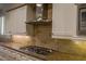 Kitchen counter features stainless appliances, light wood cabinetry, and modern range hood at 1301 Kingdom St, Las Vegas, NV 89117