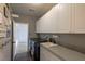 Well-organized laundry room with modern washer/dryer, utility sink, and ample cabinet space at 1301 Kingdom St, Las Vegas, NV 89117