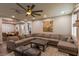 Inviting living room featuring a comfortable sectional sofa, fireplace, and a decorative ceiling fan at 1301 Kingdom St, Las Vegas, NV 89117