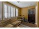Inviting living room features shuttered windows, wood floors, and comfortable tan sofa at 1301 Kingdom St, Las Vegas, NV 89117