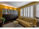 Comfortable living room with wood floors, shuttered windows, sofa and built-in cabinet at 1301 Kingdom St, Las Vegas, NV 89117