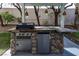 Close-up of the outdoor kitchen featuring a built-in grill, sink, and stone accents at 1301 Kingdom St, Las Vegas, NV 89117