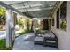 Comfortable covered patio with drapes, lounge seating, and views of lush landscaping at 1301 Kingdom St, Las Vegas, NV 89117