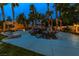 Serene pool area with a rock waterfall, slide, and comfortable lounge chairs perfect for relaxation and enjoyment at 1301 Kingdom St, Las Vegas, NV 89117