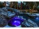 Spectacular pool featuring a rock waterfall, a spa, and vibrant blue lighting for a luxurious feel at 1301 Kingdom St, Las Vegas, NV 89117