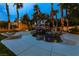 Backyard pool featuring a rock waterfall, slide, and stylish lounge chairs surrounded by palm trees at 1301 Kingdom St, Las Vegas, NV 89117