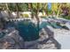 Tranquil pool with rock accents, mature palm trees, and plenty of room for lounging at 1301 Kingdom St, Las Vegas, NV 89117