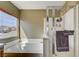 Bathroom featuring bathtub and shower with glass door, plus neighborhood view at 2265 Stone Breeze Ave, North Las Vegas, NV 89031