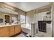 Well-lit bathroom featuring double sinks, bathtub, and walk-in shower with glass door at 2265 Stone Breeze Ave, North Las Vegas, NV 89031