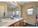 Bathroom featuring double sinks, and bathtub with floral shower curtain at 2265 Stone Breeze Ave, North Las Vegas, NV 89031