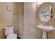 Well-lit half bathroom with pedestal sink, toilet, and tasteful decor at 2265 Stone Breeze Ave, North Las Vegas, NV 89031