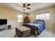 Cozy bedroom with ceiling fan and comfortable furniture and window view at 2265 Stone Breeze Ave, North Las Vegas, NV 89031