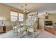 Elegant dining area with a glass-top table, stylish chairs, and a modern chandelier at 2265 Stone Breeze Ave, North Las Vegas, NV 89031