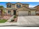 Inviting two-story home with a three-car garage and well-maintained front yard at 2265 Stone Breeze Ave, North Las Vegas, NV 89031