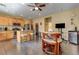 Bright eat-in kitchen featuring a breakfast bar and stainless steel refrigerator at 2265 Stone Breeze Ave, North Las Vegas, NV 89031