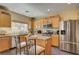 Well-lit kitchen features stainless appliances, an island, and breakfast bar at 2265 Stone Breeze Ave, North Las Vegas, NV 89031