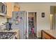 Pantry adjacent to kitchen with stainless appliances and granite countertops at 2265 Stone Breeze Ave, North Las Vegas, NV 89031