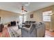 Cozy living room with hardwood floors, comfortable seating, and a ceiling fan at 2265 Stone Breeze Ave, North Las Vegas, NV 89031