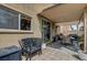 Covered patio area with tiled flooring, barbecue, and desert landscaping creates a relaxing outdoor space at 2265 Stone Breeze Ave, North Las Vegas, NV 89031