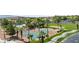 An aerial view of tennis courts, a pool, and lush landscaping create a vibrant community atmosphere at 260 Haley Way # 157, Mesquite, NV 89027