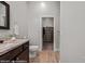 Bathroom featuring a granite countertop, under sink storage, and a walk-in closet at 260 Haley Way # 157, Mesquite, NV 89027