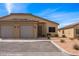 Charming home exterior with a two-car garage, desert landscaping, and a welcoming front entrance at 260 Haley Way # 157, Mesquite, NV 89027