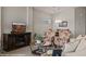 Comfortable living room with fireplace and television, plus floral chairs, and an open dining area at 260 Haley Way # 157, Mesquite, NV 89027