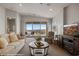 Inviting living room with vaulted ceiling, plush seating, fireplace, and stunning outdoor views at 260 Haley Way # 157, Mesquite, NV 89027