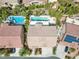 Aerial view showcases backyard pools, spa, landscaping, and solar panels of the community at 3088 Via Flaminia Ct, Henderson, NV 89052