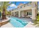 Backyard features a modern pool with waterfall feature, seating area, and covered patio at 3088 Via Flaminia Ct, Henderson, NV 89052