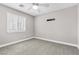 Bedroom with plush carpet, ceiling fan, and bright window with shutters at 3088 Via Flaminia Ct, Henderson, NV 89052