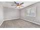 Cozy bedroom featuring plush carpet, ceiling fan and bright window with shutters at 3088 Via Flaminia Ct, Henderson, NV 89052