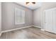 Bright bedroom featuring natural light, neutral color scheme, and wood laminate flooring at 3088 Via Flaminia Ct, Henderson, NV 89052