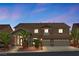 Charming two-story home featuring a stone facade, three-car garage, and well-lit entry at 3088 Via Flaminia Ct, Henderson, NV 89052