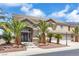 Two-story home with stone accents, desert landscaping, and a three-car garage at 3088 Via Flaminia Ct, Henderson, NV 89052