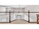 Foyer overlooks decorative wrought iron entryway with hardwood floors, and custom railing at 3088 Via Flaminia Ct, Henderson, NV 89052