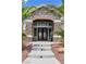 Elegant stone facade and decorative wrought iron front door, framed by palm trees at 3088 Via Flaminia Ct, Henderson, NV 89052