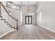 Spacious living room with hardwood floors, staircase, and elegant lighting at 3088 Via Flaminia Ct, Henderson, NV 89052